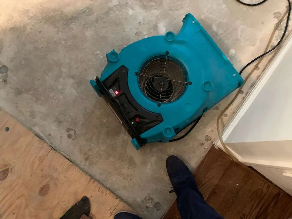 Air mover drying subfloor during Commercial Water Damage Restoration in Old Forge